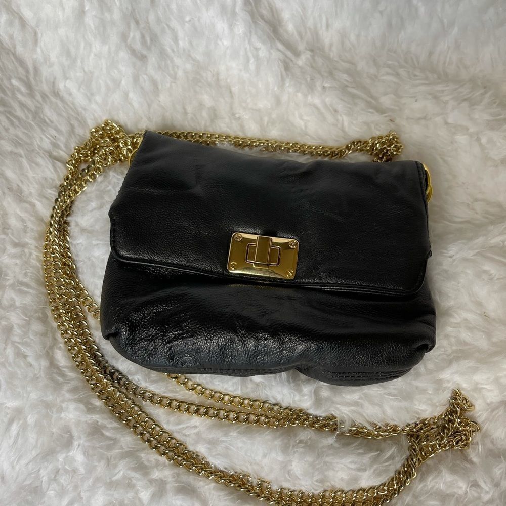 Paradox leather black small crossbody bag with ajustable gold tone chain.